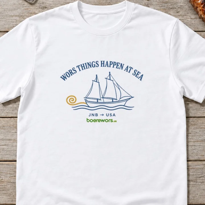 White tee printed with a sailing ship whose wake curls into a coil: Wors Things Happen at Sea, JNB to USA.
